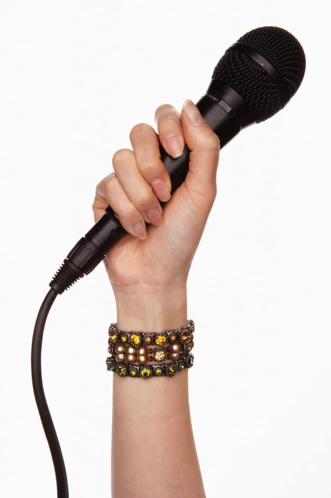 a hand holds a microphone